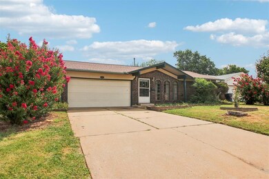 Ranch-style home with a garage and a front yard