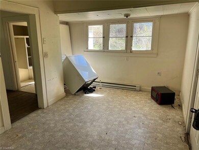 Alternate view of kitchen showing the laundry/dining area.