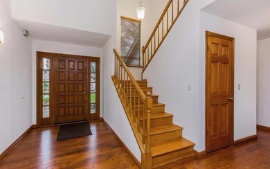 Entry with beveled side lights, hardwood floors, h