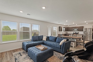 Abundant natural light pours
through windows, cre