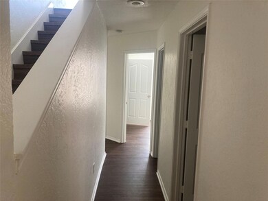 Corridor with dark hardwood / wood-style flooring