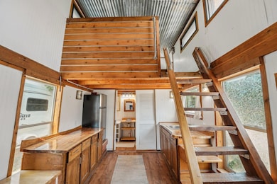 Staircase featuring wood finished floors