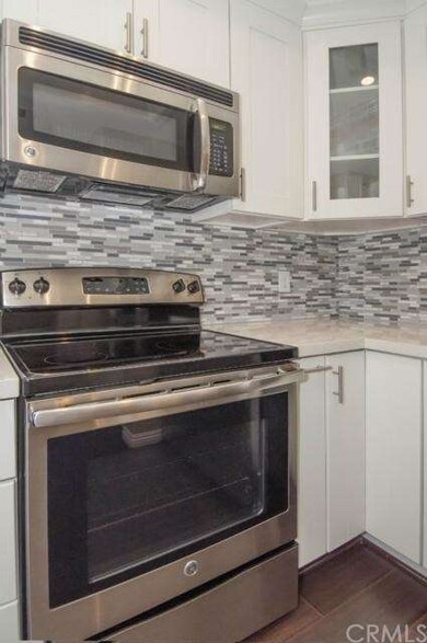 Modern tile backsplash accents the sleek stainless