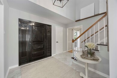 Step through the gorgeous, dark wood front door, w