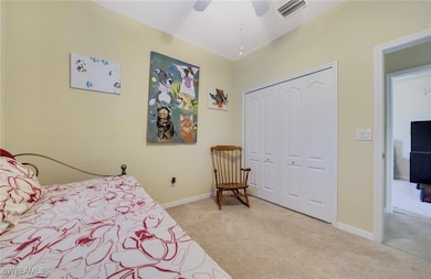 Bedroom with light carpet, a closet, and ceiling f