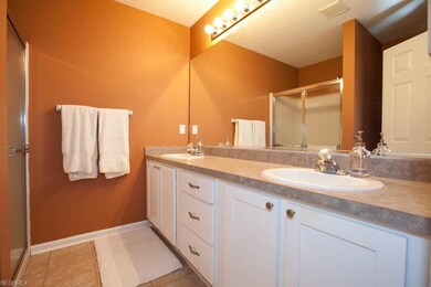 Spacious bathroom with his and her sinks and an ex
