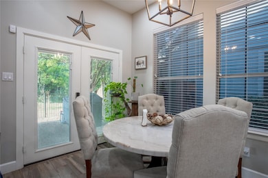 Dining space with wood finished floors and french doors