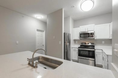 Kitchen featuring decorative backsplash, appliance