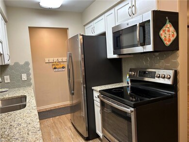 Kitchen has new stove, microwave & lighting,