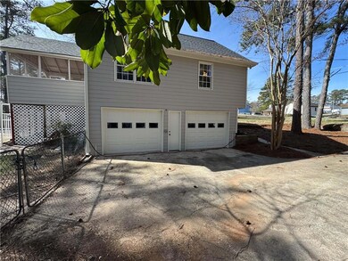 View of side of property featuring a garage, fence