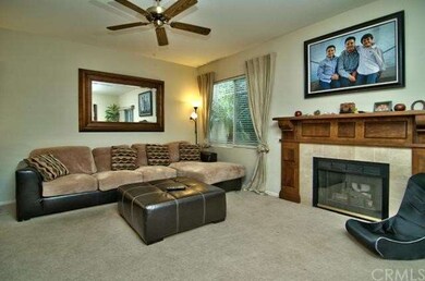 Another view of living room and fireplace with cus
