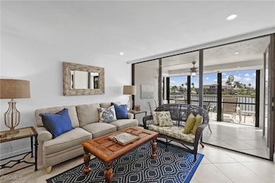 Living area featuring a wall of windows, light tile patterned flooring, ceiling fan, recessed lighting, and a water view