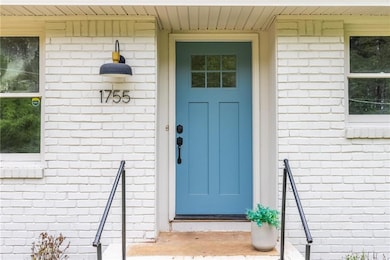 Doorway to property with updated lighting and bric