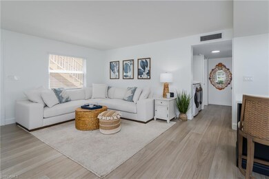 Living room featuring visible vents and light wood