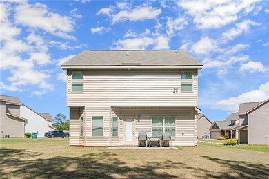 Back of property featuring a yard and a patio