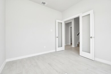 Quietly nestled in front of the home is the sophisticated home office. Featuring plush carpet, custom paint and large windows with privacy blinds. Sample photo of completed home with similar floor plan. Actual colors and selections may vary.
