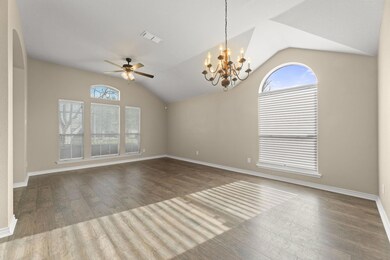 Empty room featuring vaulted ceiling, a wealth of 