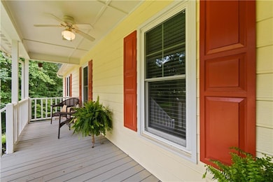 Deck featuring covered porch and ceiling fan