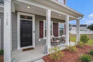 View of exterior entry featuring covered porch