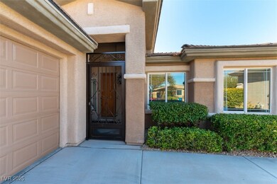 View of exterior entry with stucco siding, a garag