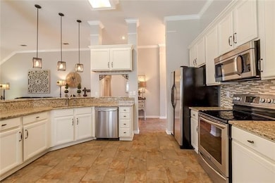 Granite countertops, stainless appliances and modern fixtures.