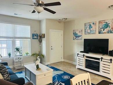Living room with ceiling fan and baseboards