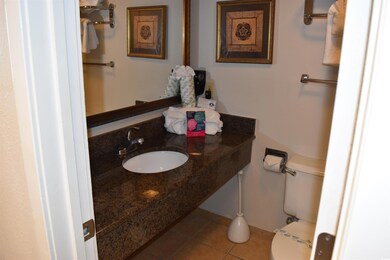 Half bathroom with tile patterned flooring, a sink