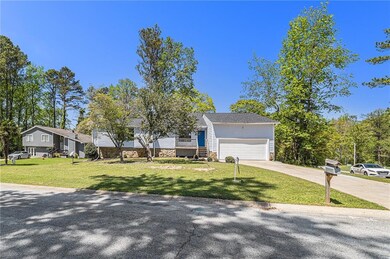 View of front of home with driveway, a front yard,