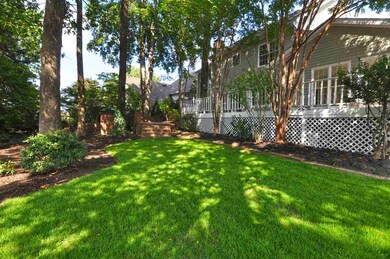 The backyard features a beautifully manicured lawn