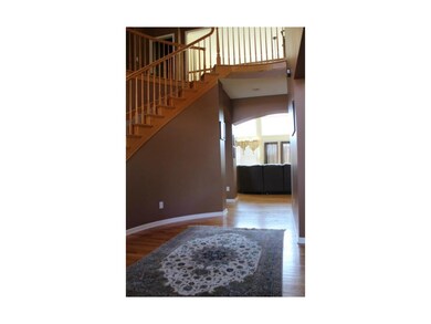 Entryway and staircase with handcrafted spindles.