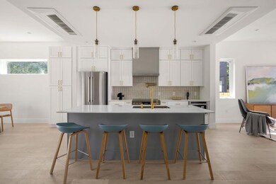 Kitchen featuring light countertops, backsplash, 