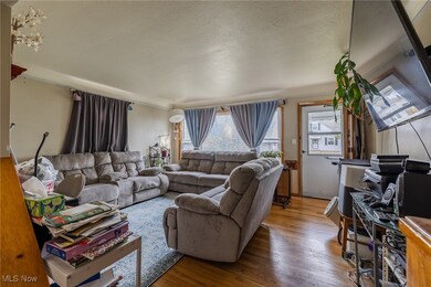 Living area with wood finished floors, healthy amount of natural light, and a textured ceiling