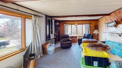 Interior space featuring wood walls and beamed cei