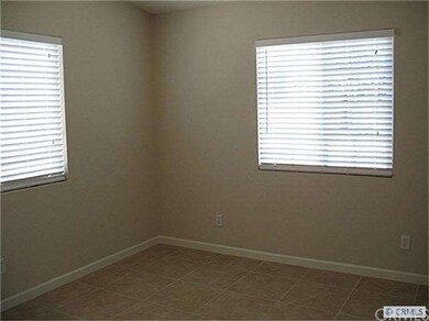 Master bedroom with tile floor