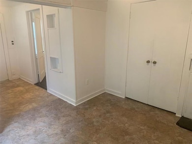Unfurnished bedroom featuring tile patterned floors