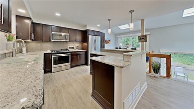 Espresso cabinetry with granite counter tops.