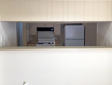 Kitchen featuring light countertops, a peninsula,
