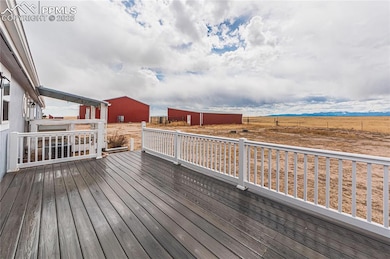 Deck with an outdoor structure and a pole building