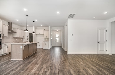 The gourmet kitchen perfectly flows into the large great room + dining area...