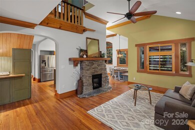 Vaulted ceiling in Living room, plus a custom stone gas fireplace.