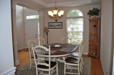 Open dining room with crown molding and natural lighting!