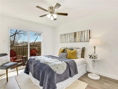 Bedroom with access to outside, baseboards, wood 