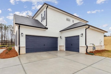 View of side of property with an attached garage, 