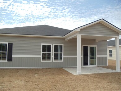 Back of house with roof with shingles and a patio