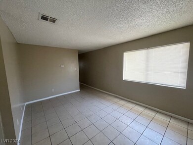 Apt 1's Spacious Living Room w/ Tile Flooring & Tw