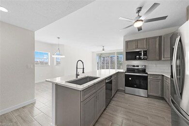 Kitchen with sink, hanging light fixtures, decorat
