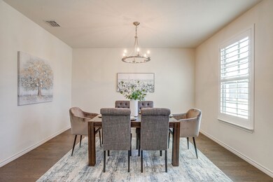 Dining space with a chandelier and wood finished floors