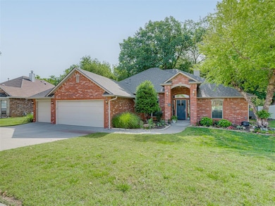 View of front of home with an attached garage, a shingled roof, a chimney, brick siding, and a front yard