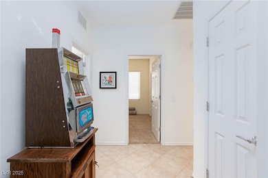 Hall featuring light tile patterned floors