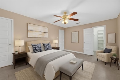 Experience the comfort of this inviting
room with neutral beige walls, sleek
modern tile flooring, and a stylish ceiling
fan. The crisp white trim and door
enhance its clean, welcoming
ambiance.